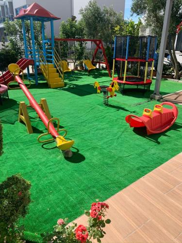 a playground with many different types of playground equipment at Hotel Lakaj 2 in Velipojë