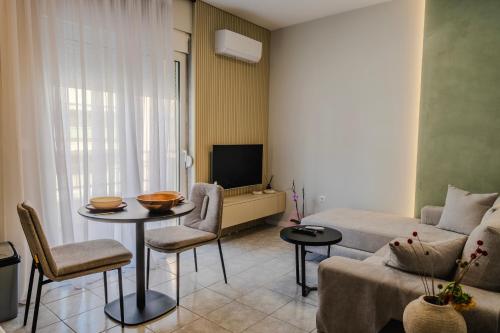 a living room with a couch and a table at Urban Gem-Fresh & Central in Alexandroupoli