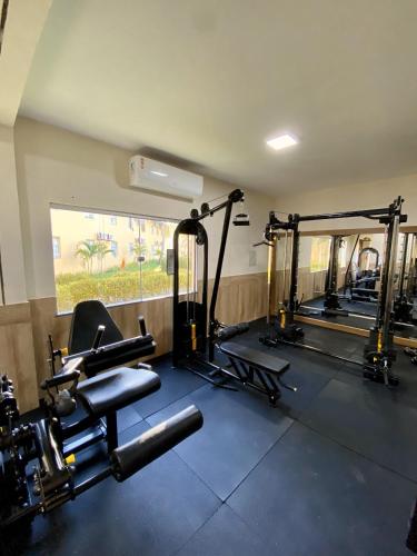 a gym with several tread machines in a room at Portobello Park Hotel in Porto Seguro