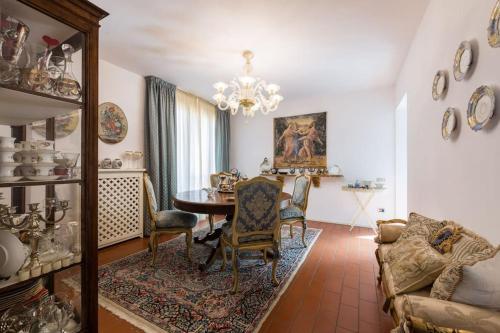 a living room with a table and chairs and a chandelier at Tuscany Modern Luxury Villa, 450sqm in Ponsacco