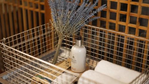 a bottle of soap and a vase with a plant at Unwadang Private Luxury Hanok House in bukchon in Seoul
