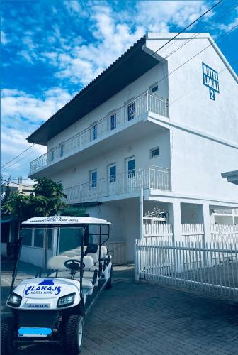 a golf cart parked in front of a building at Hotel Lakaj 2 in Velipojë