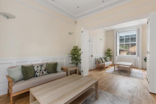 a living room with a couch and a table at Parea Living - Spacious 4 Story House, Families, Big Groups in London