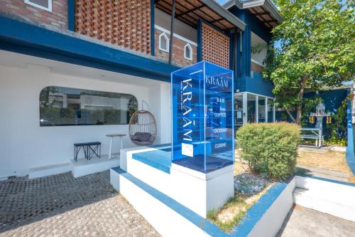 a blue sign on the side of a building at KRAAM Silhouette Hotel and Cafe Phuket in Chalong 