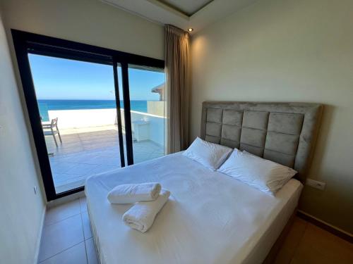 Postel nebo postele na pokoji v ubytování Seaside Apartments