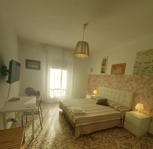 a bedroom with a bed and a desk in it at Casa Piazza del Santo in Padova