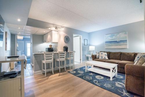 a living room and kitchen with a couch and a table at Biscayne Suites in Ocean City