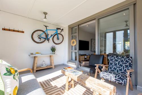 a living room with a bike hanging on the wall at Waddle Inn Luxury apartment in Franschhoek in Franschhoek
