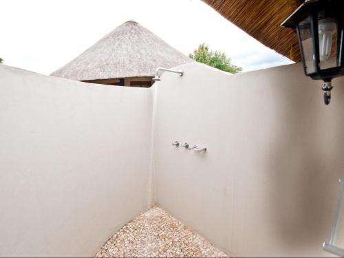 a white fence with three pigeons on it at Ubizane Zululand Safari Lodge in Hluhluwe
