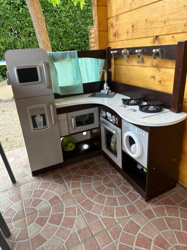 a pretend kitchen with a stove and a sink at Magnifique chalet aux portes de la Drôme in Saint-Rambert-dʼAlbon