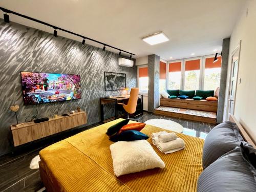 a room with a bed and a tv on a wall at Stay in Skopje - Prime Location Apartment in Skopje
