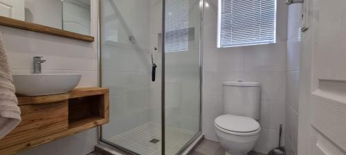 a bathroom with a toilet and a sink at Pearly Dunes in Pearly Beach
