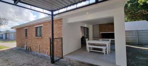 an external view of a house with a patio at Pearly Dunes in Pearly Beach