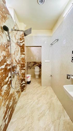 a bathroom with a shower and a toilet and a sink at Himaksh Homestay in Varanasi