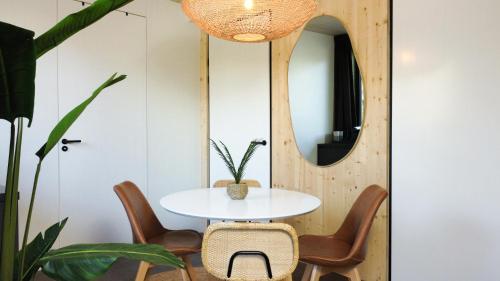 a room with a table and chairs and a mirror at Hike & Bike Hotel in Noordwolde