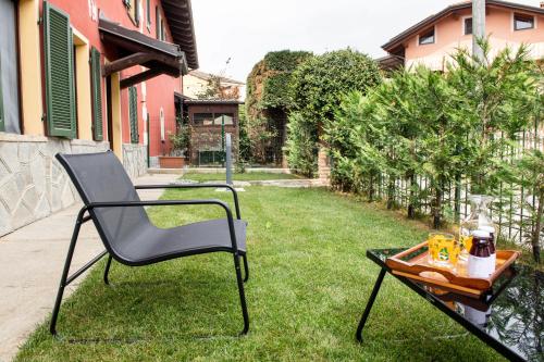 a chair and a table in a yard at Agriturismo Ca' del Clat in Bagnolo Piemonte