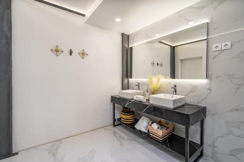 a bathroom with two sinks and a mirror at Host Wise - Elegant Loft with Historic Charm & Terrace in Portel