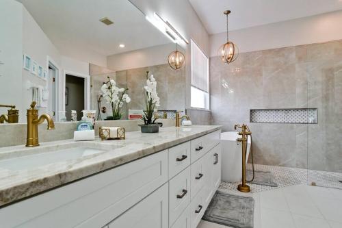 a bathroom with a large sink and a shower at The Pool House - Private, Heated Pool in Elwood Park
