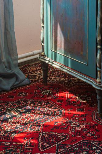 a rug on the floor next to a dresser at The Forgotten Kingdom in Lchashen