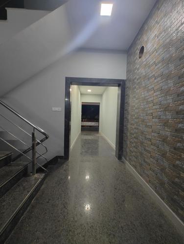 an empty hallway with a brick wall and stairs at JP Residency, near to Isha, Adhiyogi & Karunya in Alāndurai