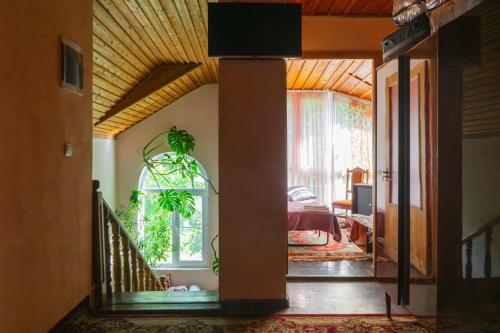 a living room with a staircase and a bedroom at The Forgotten Kingdom in Lchashen