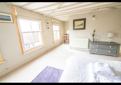 a large bedroom with a bed and a window at Benson House - Rye Town Centre, East Sussex in Rye