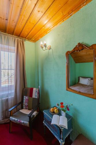 a room with a mirror and a chair and a table at The Forgotten Kingdom in Lchashen