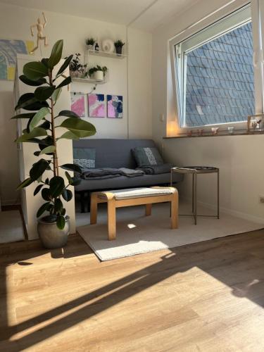 a living room with a couch and a table at Schönes Apartment mit Balkon Aggertalsperre in Bergneustadt