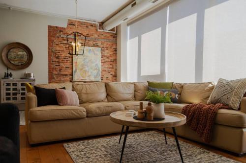 a living room with a couch and a table at The Alford Building Two bedroom loft downtown in Kingston