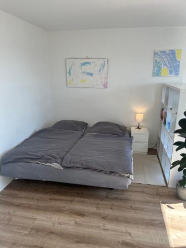 a bed in a white room with at Schönes Apartment mit Balkon Aggertalsperre in Bergneustadt