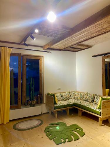 a living room with a couch and a window at Eco Art House in Vanadzor