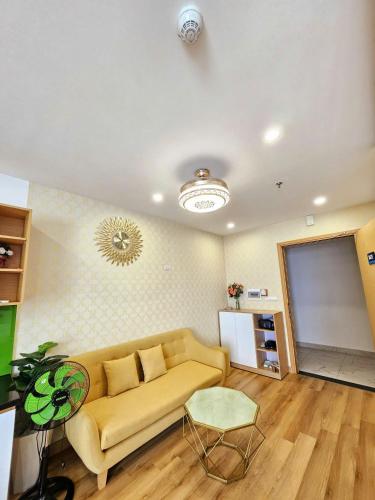 a living room with a couch and a table at Seafront Apartment TMS Quy Nhơn in Quy Nhon