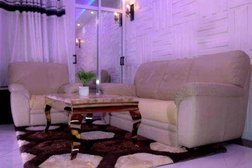 a living room with a couch and a table at Matcheu Palace Hôtel in Djoungolo