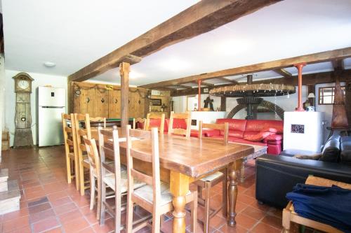 a dining room with a wooden table and chairs at Le moulin de Varax in Saint-Paul-de-Varax