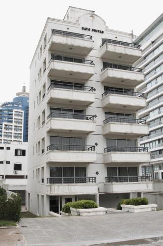 a white building with balconies on the side of it at Hotel Sunset Beach in Punta del Este