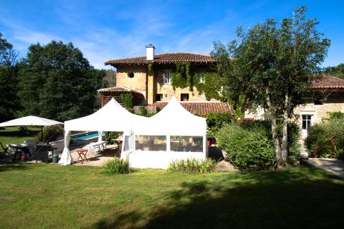 a white tent in front of a house at Le moulin de Varax in Saint-Paul-de-Varax