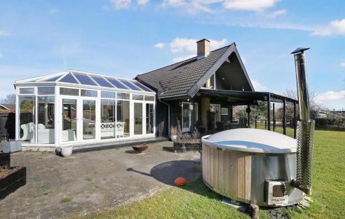 a large house with a greenhouse and a hot tub at 3 Bedroom Stunning Home In Hundested in Hundested