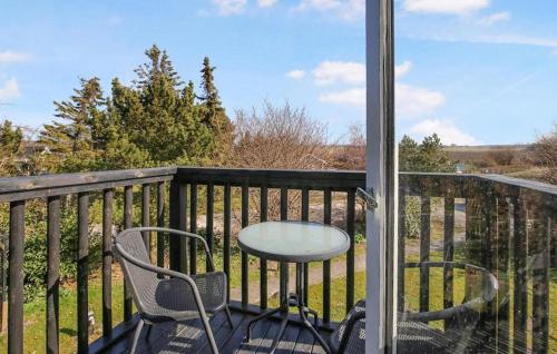 a table and chairs on a balcony with a view at 3 Bedroom Stunning Home In Hundested in Hundested