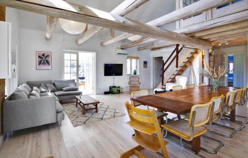 a large living room with a wooden table and chairs at 3 Bedroom Stunning Home In Hundested in Hundested