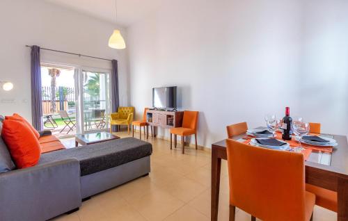a living room with a table and a dining room at Gorgeous Home In Condado De Alhama in El Romero