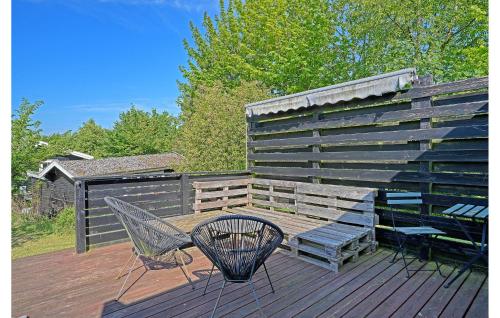 a deck with a bench and a table and a fence at Lovely Home In Holbæk With Wifi in Holbæk