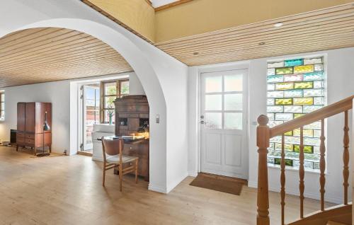 a dining room with a table and a stained glass window at 4 Bedroom Gorgeous Home In Nørre Alslev in Nørre Alslev