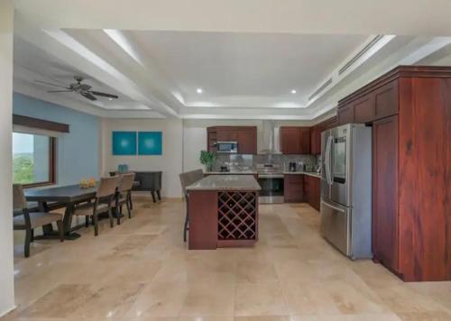a large kitchen and dining room with a dining table at Coral Paradise in Crawfish Rock
