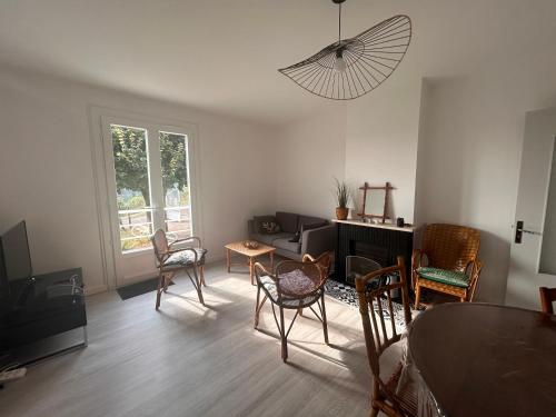a living room with a table and chairs at Maison au coeur du Périgord Vert in Javerlhac-et-la-Chapelle-Saint-Robert