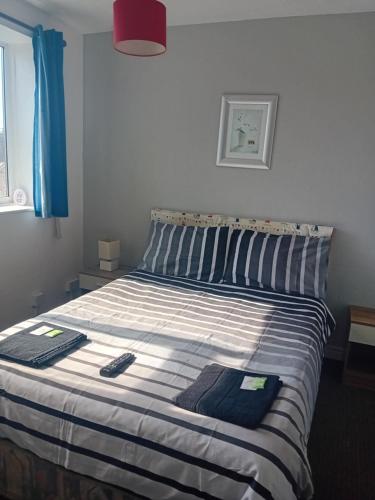 a bed in a bedroom with two towels on it at MyRoomz New Discovery Hotel in Blackpool