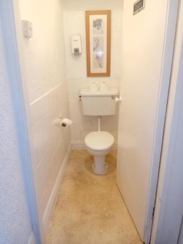 a bathroom with a white toilet in a room at MyRoomz New Discovery Hotel in Blackpool