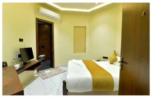 a hotel room with a bed and a television at Yashvrinda in Mandor