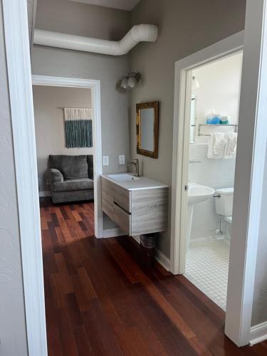 a bathroom with a sink and a tub and a mirror at Casa Marina Hotel & Restaurant - Jacksonville Beach in Jacksonville Beach
