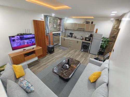 a living room with a couch and a kitchen at Harmony in Azrou