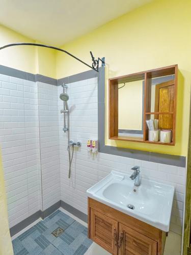 a bathroom with a sink and a shower at Luang Phasouk Hotel in Luang Prabang